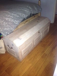 A pine chest at foot of daughter, Julie's bed.